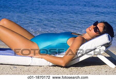 Pregnant woman sunbathing on beach View Large Photo Image Stock Image - Pregnant woman sunbathing on beach. Fotosearch