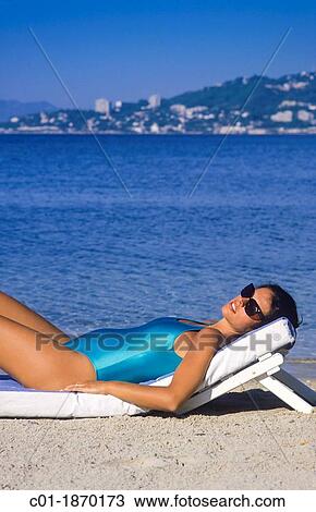 Pregnant woman sunbathing on beach View Large Photo Image Stock Image - Pregnant woman sunbathing on beach. Fotosearch