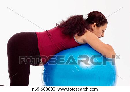 Pregnant woman using an exercise ball. View Large Photo Image Stock Image - Pregnant woman using an exercise ball.. Fotosearch