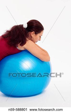Stock Image - Pregnant woman using an exercise ball.. Fotosearch