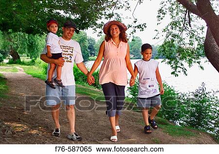 Pregnant woman walking alongside river with her husband and two young boys. View Large Photo Image Stock Photography - Pregnant woman walking alongside river with her husband and two young boys.. Fotosearch