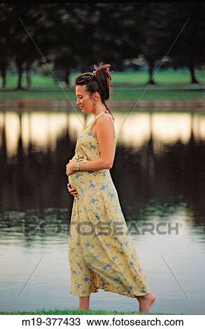 pregnant woman walking by a lake View Large Photo Image Stock Image - pregnant woman walking by a lake. Fotosearch