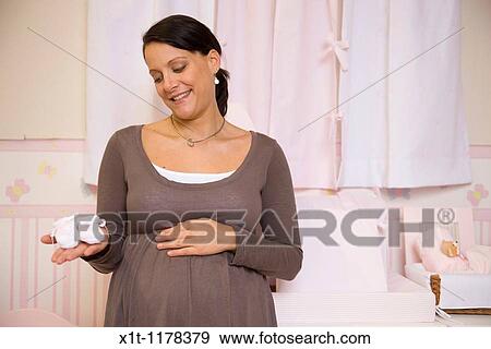 Pregnant woman with baby booties. View Large Photo Image Stock Photo - Pregnant woman with baby booties.. Fotosearch