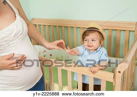 Stock Photo - Pregnant woman with her young nephew.. Fotosearch