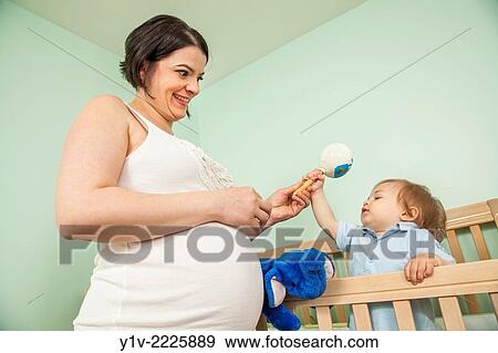 Stock Photo - Pregnant woman with her young nephew.. Fotosearch