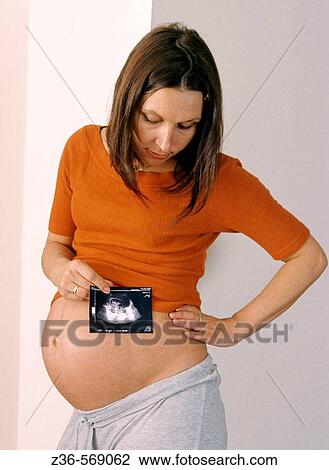 Pregnant woman with x-ray picture View Large Photo Image Stock Image - Pregnant woman with x-ray picture. Fotosearch