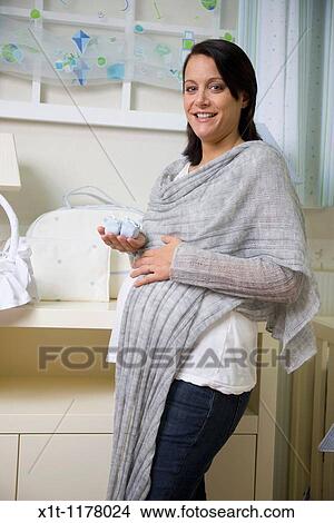 Picture - Pregnant women in the baby's room.. Fotosearch
