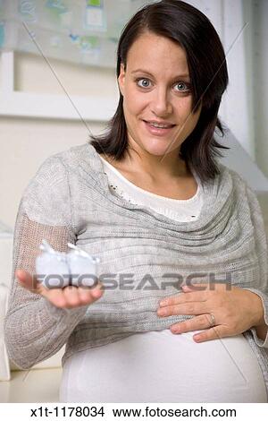 Pregnant women in the baby's room. View Large Photo Image Picture - Pregnant women in the baby's room.. Fotosearch