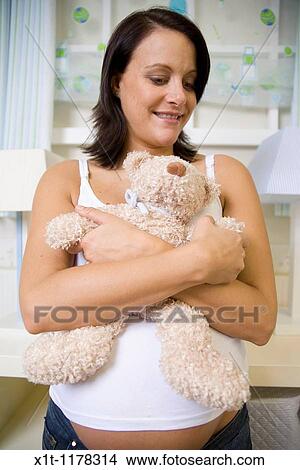 Pregnant women in the baby's room. View Large Photo Image Picture - Pregnant women in the baby's room.. Fotosearch