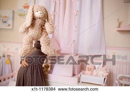 Pregnant women in the baby's room. View Large Photo Image Picture - Pregnant women in the baby's room.. Fotosearch