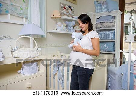 Pregnant women in the baby's room. View Large Photo Image Stock Image - Pregnant women in the baby's room.. Fotosearch