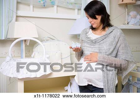 Pregnant women in the baby's room. View Large Photo Image Stock Image - Pregnant women in the baby's room.. Fotosearch