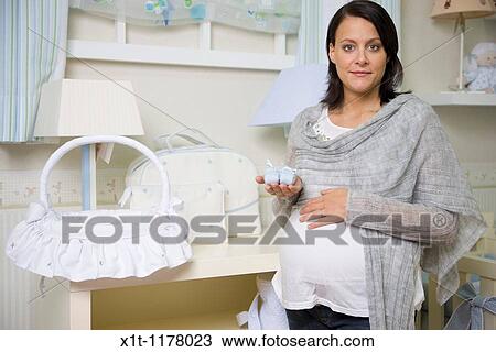 Stock Image - Pregnant women in the baby's room.. Fotosearch