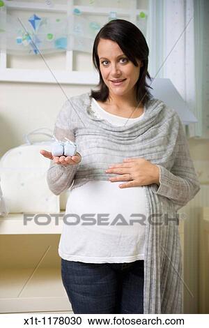 Pregnant women in the baby's room. View Large Photo Image Stock Image - Pregnant women in the baby's room.. Fotosearch