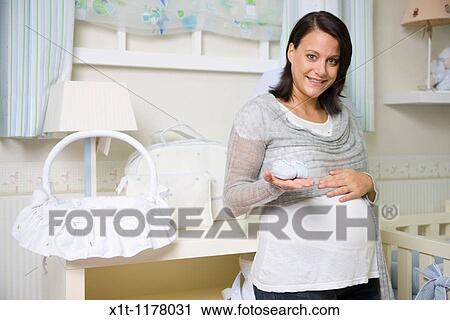 Pregnant women in the baby's room. View Large Photo Image Stock Image - Pregnant women in the baby's room.. Fotosearch