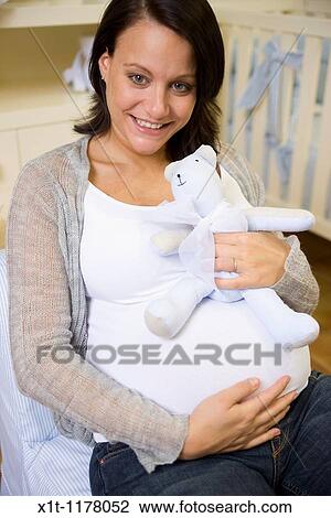 Pregnant women in the baby's room. View Large Photo Image Stock Image - Pregnant women in the baby's room.. Fotosearch