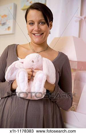 Pregnant women in the baby's room. View Large Photo Image Stock Image - Pregnant women in the baby's room.. Fotosearch