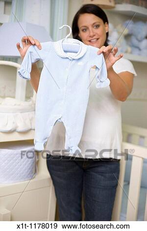 Pregnant women in the baby's room. View Large Photo Image Stock Photo - Pregnant women in the baby's room.. Fotosearch