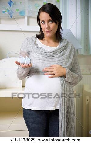 Stock Photo - Pregnant women in the baby's room.. Fotosearch