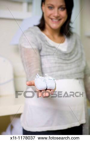 Stock Photo - Pregnant women in the baby's room.. Fotosearch