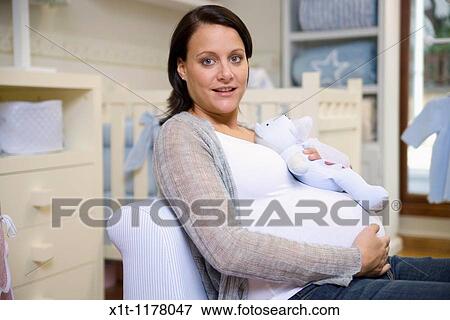 Stock Photo - Pregnant women in the baby's room.. Fotosearch