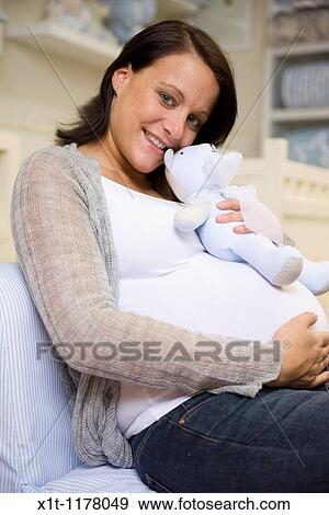 Pregnant women in the baby's room. View Large Photo Image Stock Photo - Pregnant women in the baby's room.. Fotosearch