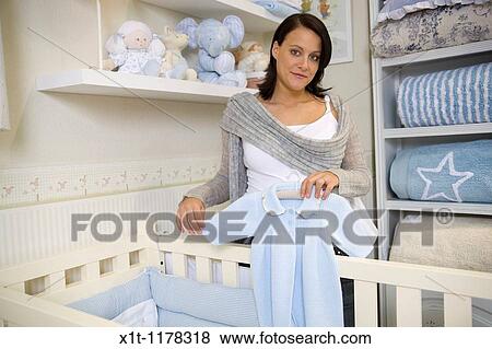 Pregnant women in the baby's room. View Large Photo Image Stock Photo - Pregnant women in the baby's room.. Fotosearch