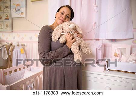 Pregnant women in the baby's room. View Large Photo Image Stock Photo - Pregnant women in the baby's room.. Fotosearch