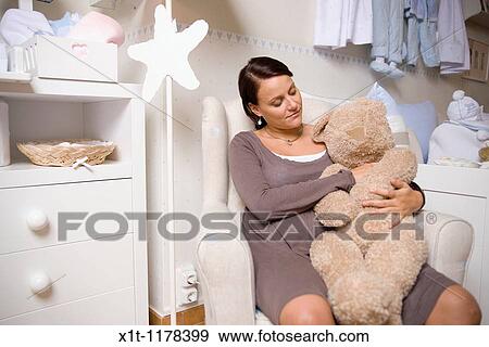 Stock Photo - Pregnant women in the baby's room.. Fotosearch