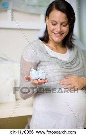Stock Photograph - Pregnant women in the baby's room.. Fotosearch