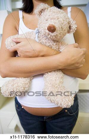 Pregnant women in the baby's room. View Large Photo Image Stock Photograph - Pregnant women in the baby's room.. Fotosearch