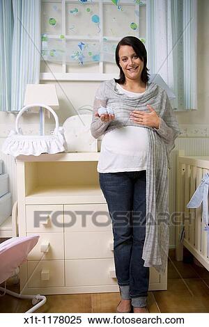 Stock Photography - Pregnant women in the baby's room.. Fotosearch