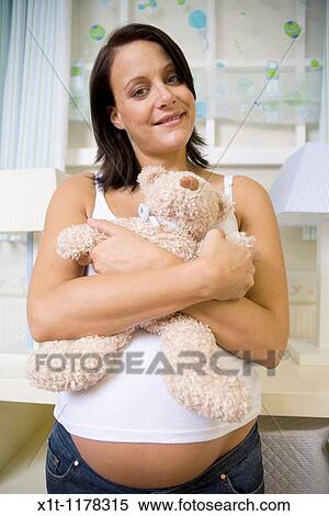 Pregnant women in the baby's room. View Large Photo Image Stock Photography - Pregnant women in the baby's room.. Fotosearch