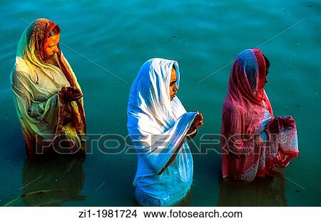 pregnant women offer fruit to the Gods in the Ganges and pray for receiving a boy. Varanasi, India View Large Photo Image Picture - pregnant women offer fruit to the Gods in the Ganges and pray for receiving a boy. Varanasi, India. Fotosearch