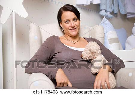 Stock Image - Pregnant women with Stuffed Animals.. Fotosearch