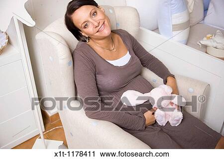 Stock Image - Pregnant women with Stuffed Animals.. Fotosearch
