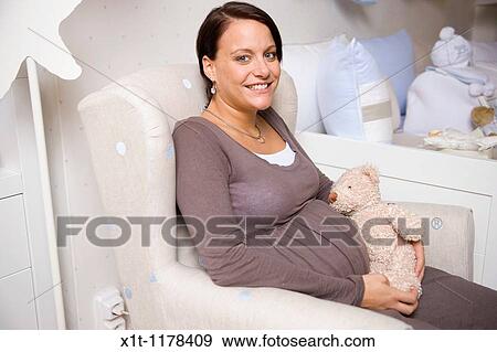 Stock Photo - Pregnant women with Stuffed Animals.. Fotosearch