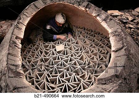 Preparing a burning of? zellige? (ceramic tiles) at the? Cooperative de Maalems Zelligeurs?, at A? n Nokbi, outside Fes. Morocco. View Large Photo Image Picture - Preparing a burning of? zellige? (ceramic tiles) at the? Cooperative de Maalems Zelligeurs?, at A? n Nokbi, outside Fes. Morocco.. Fotosearch