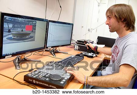 Stock Image - Preparing a scientific article on digital TV, digital TV and multimedia services, Vicomtech-IK4 Visual Interaction and Communication Technologies Centre, applied research centre for Interactive Computer Graphics and Multimedia. Fotosearch