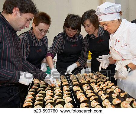 Stock Image - Preparing canapes (snack with prawn, salmon, potato and avocado), Divinus Catering, San Sebastian, Donostia, Gipuzkoa, Basque Country. Fotosearch