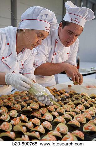 Stock Photography - Preparing canapes (snack with prawn, salmon, potato and avocado), Divinus Catering, San Sebastian, Donostia, Gipuzkoa, Basque Country. Fotosearch