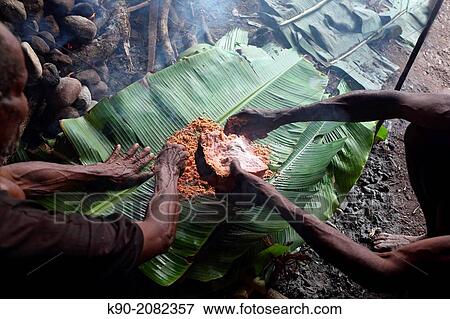 Preparing traditional sago bread by cooking sago flour in banana leaves, Papua, Indonesia, Southeast Asia. View Large Photo Image Stock Photo - Preparing traditional sago bread by cooking sago flour in banana leaves, Papua, Indonesia, Southeast Asia.. Fotosearch