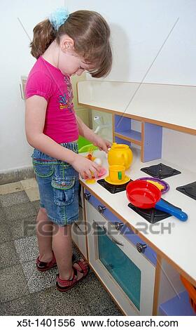 Preschool girl of 5 plays with a toy kitchen View Large Photo Image Stock Photograph - Preschool girl of 5 plays with a toy kitchen. Fotosearch