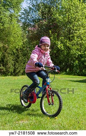 Preschool girl riding her bicycle. View Large Photo Image Stock Photo - Preschool girl riding her bicycle.. Fotosearch