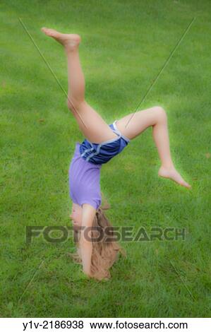 Stock Photo - Preteen blond girl doing gymnastics.. Fotosearch