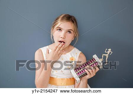 Stock Photo - Preteen blond girl holding a trophy.. Fotosearch