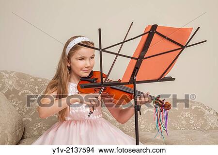Picture - Preteen blond girl practicing the viola.. Fotosearch
