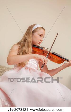 Preteen blond girl practicing the viola. View Large Photo Image Stock Image - Preteen blond girl practicing the viola.. Fotosearch