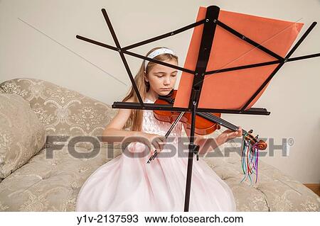 Preteen blond girl practicing the viola. View Large Photo Image Stock Image - Preteen blond girl practicing the viola.. Fotosearch