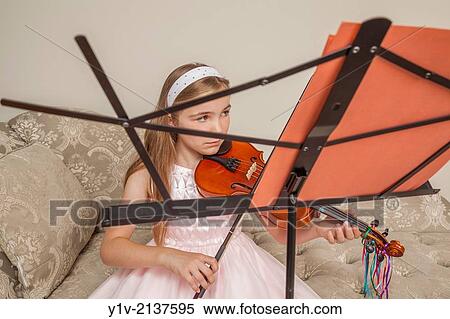 Stock Photography - Preteen blond girl practicing the viola.. Fotosearch